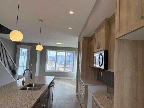 24 Sundown Place, Cochrane, AB - Indoor Photo Showing Kitchen With Double Sink