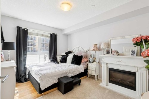 3110-279 Copperpond Common Se, Calgary, AB - Indoor Photo Showing Bedroom With Fireplace