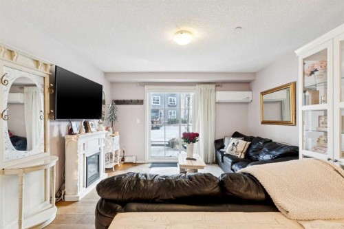 3110-279 Copperpond Common Se, Calgary, AB - Indoor Photo Showing Other Room With Fireplace