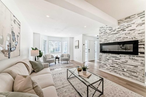 34 River Rock Way Se, Calgary, AB - Indoor Photo Showing Living Room With Fireplace