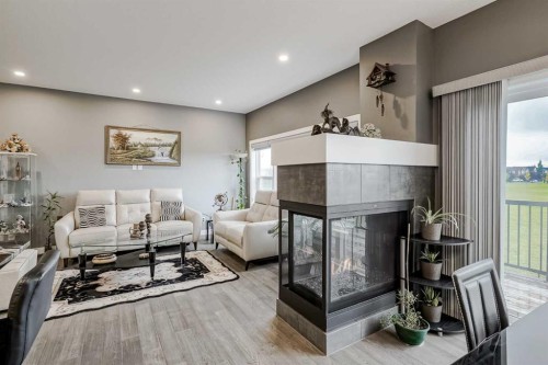 32 Legacy Cove Se, Calgary, AB - Indoor Photo Showing Living Room With Fireplace