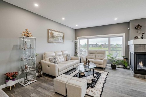 32 Legacy Cove Se, Calgary, AB - Indoor Photo Showing Living Room With Fireplace