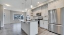 205 Sundown Road, Cochrane, AB  - Indoor Photo Showing Kitchen With Upgraded Kitchen 