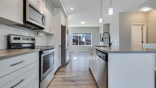 205 Sundown Road, Cochrane, AB - Indoor Photo Showing Kitchen With Upgraded Kitchen