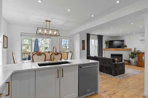 72 Crystalridge Crescent, Okotoks, AB - Indoor Photo Showing Kitchen With Fireplace