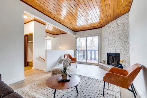 F-1415 44 Street Se, Calgary, AB - Indoor Photo Showing Living Room With Fireplace