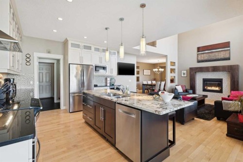44 Aspen Summit Drive Sw, Calgary, AB - Indoor Photo Showing Kitchen With Fireplace With Double Sink With Upgraded Kitchen