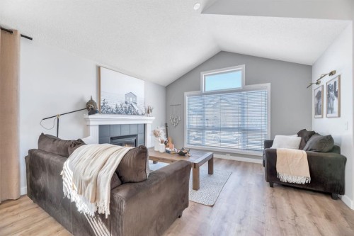 75 Copperfield Rise Se, Calgary, AB - Indoor Photo Showing Living Room With Fireplace