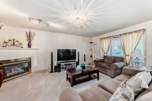 198 Copperfield Gardens Se, Calgary, AB - Indoor Photo Showing Living Room With Fireplace