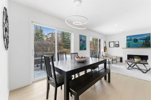 40 Tuscany Ridge Green Nw, Calgary, AB - Indoor Photo Showing Dining Room With Fireplace