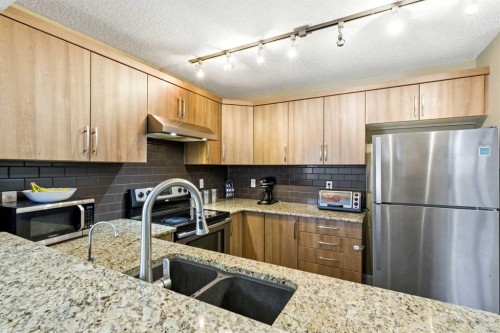 1441 Windstone Road Sw, Airdrie, AB - Indoor Photo Showing Kitchen With Double Sink With Upgraded Kitchen