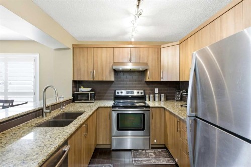 1441 Windstone Road Sw, Airdrie, AB - Indoor Photo Showing Kitchen With Double Sink With Upgraded Kitchen