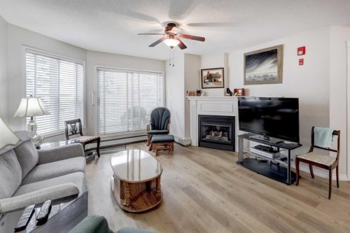 101-6800 Hunterview Drive Nw, Calgary, AB - Indoor Photo Showing Living Room With Fireplace