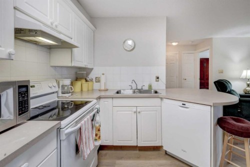 101-6800 Hunterview Drive Nw, Calgary, AB - Indoor Photo Showing Kitchen With Double Sink
