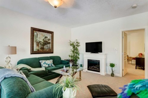 55 Tucker Circle, Okotoks, AB - Indoor Photo Showing Living Room With Fireplace