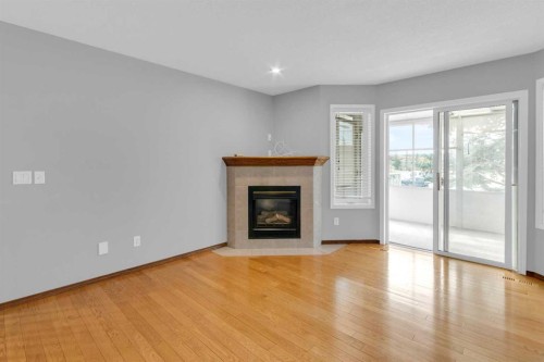 4-604 Griffin Road West, Cochrane, AB - Indoor Photo Showing Living Room With Fireplace