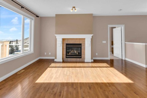 106-1000 Glenhaven Way, Cochrane, AB - Indoor Photo Showing Living Room With Fireplace