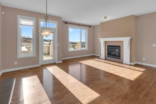 106-1000 Glenhaven Way, Cochrane, AB - Indoor Photo Showing Living Room With Fireplace