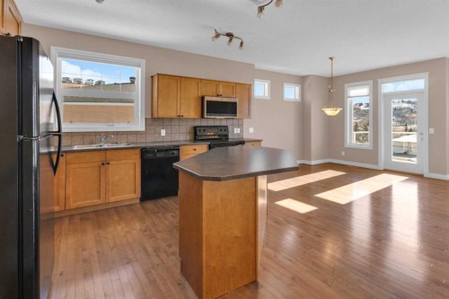 106-1000 Glenhaven Way, Cochrane, AB - Indoor Photo Showing Kitchen With Double Sink