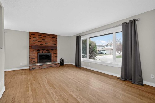 14543 Parkside Drive Se, Calgary, AB - Indoor Photo Showing Living Room With Fireplace