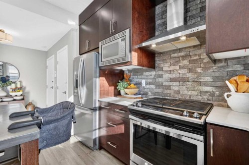 203-445 Redstone Ne, Calgary, AB - Indoor Photo Showing Kitchen With Stainless Steel Kitchen With Upgraded Kitchen