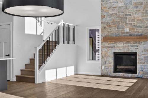 709 Dawson Common, Chestermere, AB - Indoor Photo Showing Other Room With Fireplace