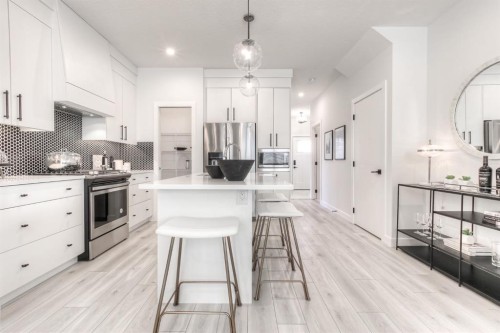 34 Bridgeport Circle, Chestermere, AB - Indoor Photo Showing Kitchen With Stainless Steel Kitchen With Upgraded Kitchen
