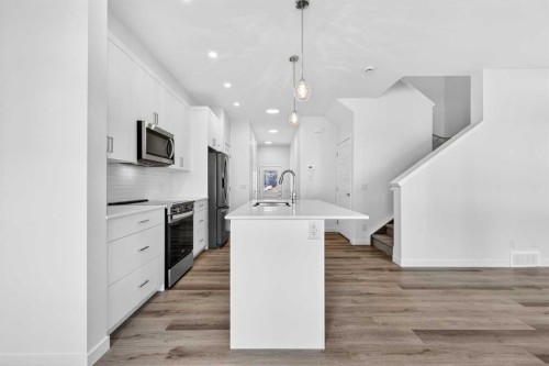 50 Creekside Way Sw, Calgary, AB - Indoor Photo Showing Kitchen With Upgraded Kitchen