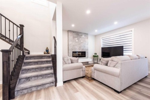 137 Edith Villas Nw, Calgary, AB - Indoor Photo Showing Living Room With Fireplace