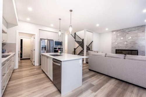 137 Edith Villas Nw, Calgary, AB - Indoor Photo Showing Kitchen With Fireplace With Upgraded Kitchen