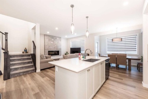 137 Edith Villas Nw, Calgary, AB - Indoor Photo Showing Kitchen With Fireplace With Upgraded Kitchen