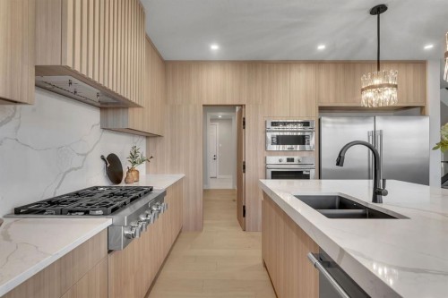 28 Spring Creek Point Sw, Calgary, AB - Indoor Photo Showing Kitchen With Double Sink With Upgraded Kitchen