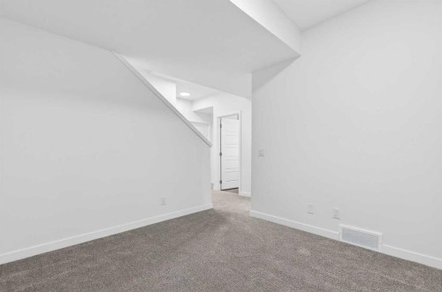 54 Creekside Way Sw, Calgary, AB - Indoor Photo Showing Other Room