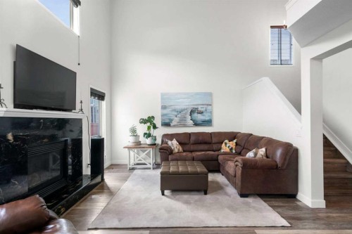 176 Douglas Ridge Green Se, Calgary, AB - Indoor Photo Showing Living Room With Fireplace