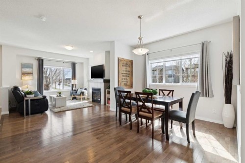 8 Walgrove Green Se, Calgary, AB - Indoor Photo Showing Dining Room With Fireplace