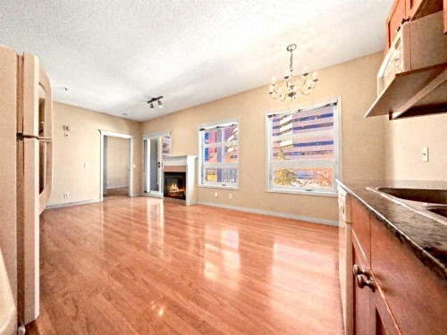 209-333 Riverfront Avenue Se, Calgary, AB - Indoor Photo Showing Kitchen With Fireplace