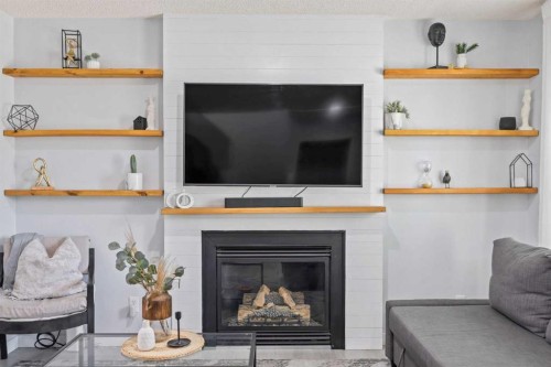 371 Silverado Drive Sw, Calgary, AB - Indoor Photo Showing Living Room With Fireplace