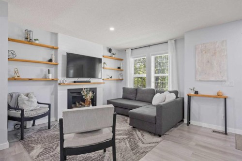 371 Silverado Drive Sw, Calgary, AB - Indoor Photo Showing Living Room With Fireplace