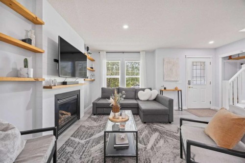 371 Silverado Drive Sw, Calgary, AB - Indoor Photo Showing Living Room With Fireplace