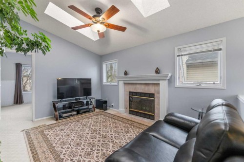 14950 Mt Mckenzie Drive Se, Calgary, AB - Indoor Photo Showing Living Room With Fireplace