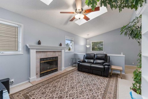 14950 Mt Mckenzie Drive Se, Calgary, AB - Indoor Photo Showing Living Room With Fireplace