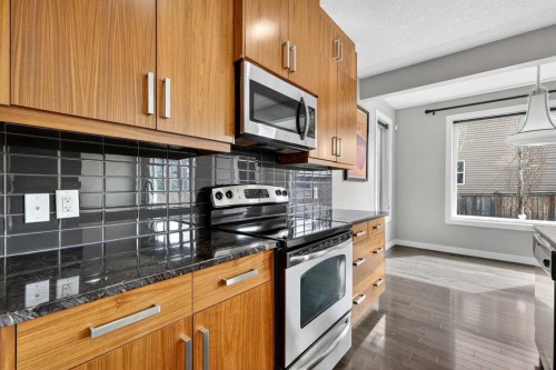 31 Evansridge Close Nw, Calgary, AB - Indoor Photo Showing Kitchen With Fireplace With Double Sink