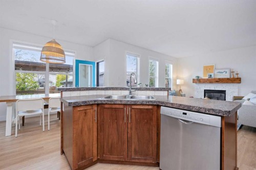160 Prestwick Manor Se, Calgary, AB - Indoor Photo Showing Kitchen With Fireplace With Double Sink