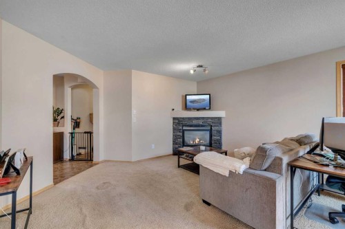 100 Covecreek Close Ne, Calgary, AB - Indoor Photo Showing Living Room With Fireplace