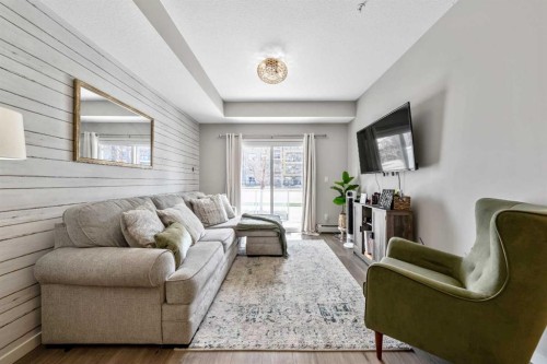 117-4150 Seton Drive Se, Calgary, AB - Indoor Photo Showing Living Room