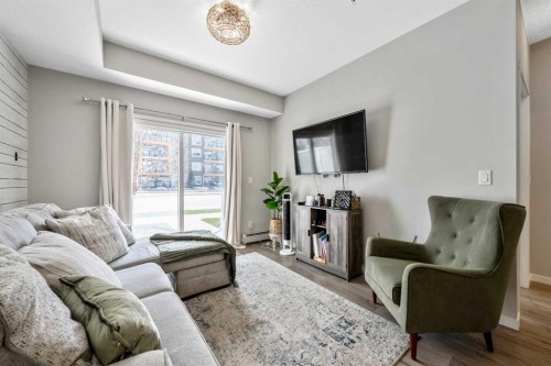 117-4150 Seton Drive Se, Calgary, AB - Indoor Photo Showing Living Room