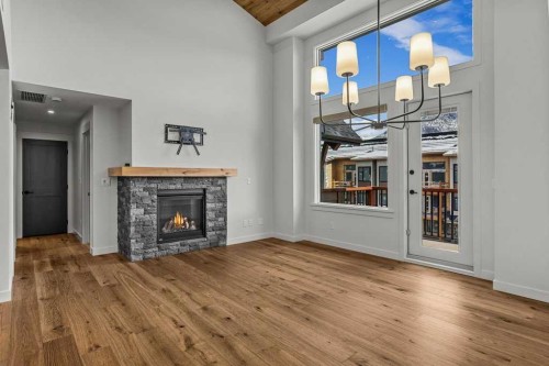 401-1505 Spring Creek Gate, Canmore, AB - Indoor Photo Showing Living Room With Fireplace