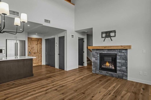 401-1505 Spring Creek Gate, Canmore, AB - Indoor Photo Showing Living Room With Fireplace