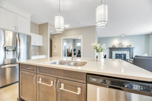 143 Stonemere Green, Chestermere, AB - Indoor Photo Showing Kitchen With Stainless Steel Kitchen With Double Sink
