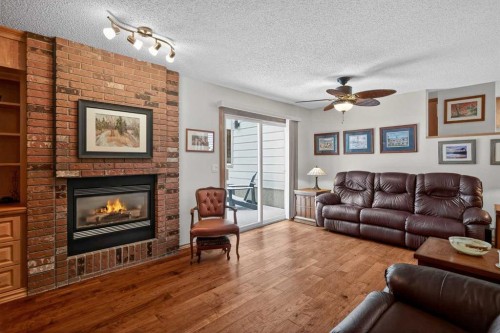28 Deercross Way Se, Calgary, AB - Indoor Photo Showing Living Room With Fireplace